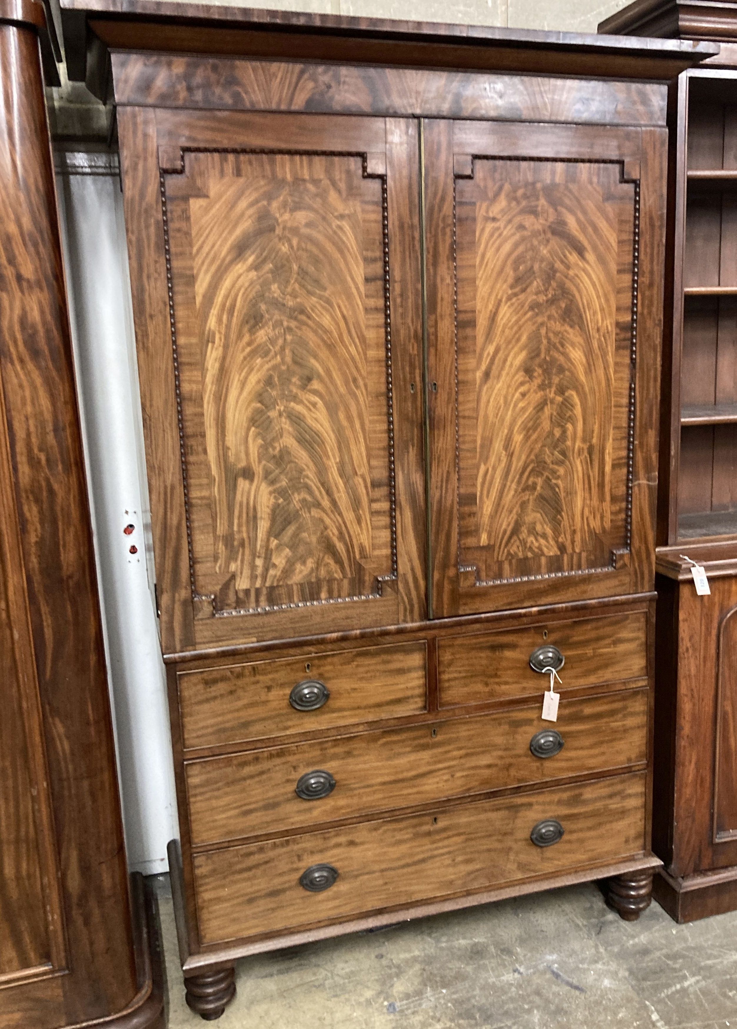 A Victorian figured mahogany linen press, width 130cm, depth 56cm, height 218cm